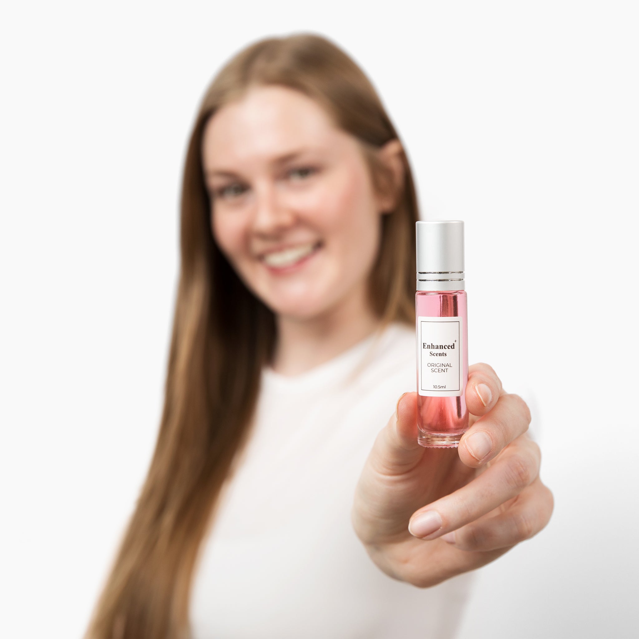 Couple posing with a bottle of 'Venom' pheromone spray.